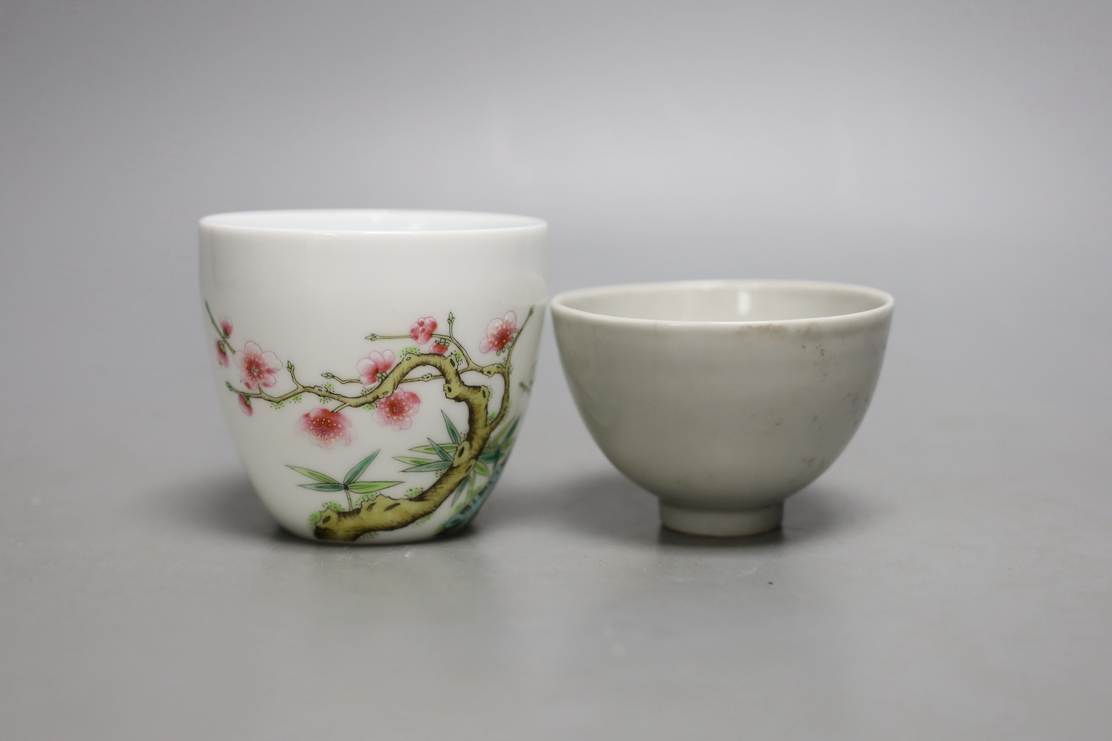 A Chinese internally moulded porcelain cup and a famille rose cup, 7cms high